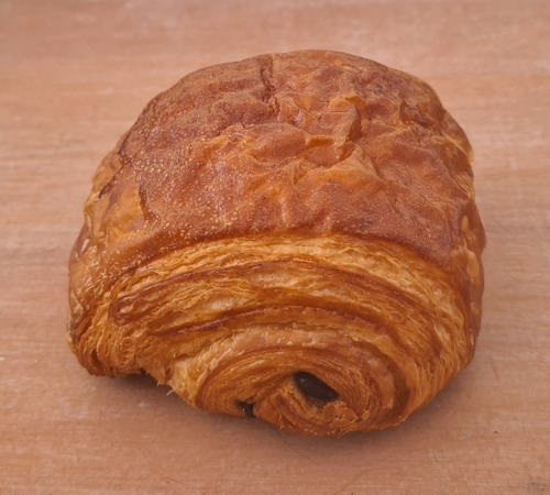 Golden French pain au chocolat with two dark chocolate bars – handmade pastry in Brisbane and Gold Coast bakery